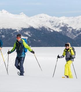 Four people are snowshoeing